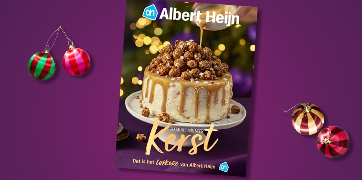 Albert Heijn kerstmagazine met een feestelijke taart en kerstballen op een paarse achtergrond