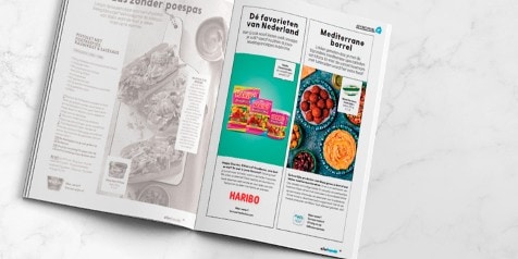 Reclamepagina in een magazine met aanbiedingen van Haribo snoepjes en Mediterrane borrelhapjes.