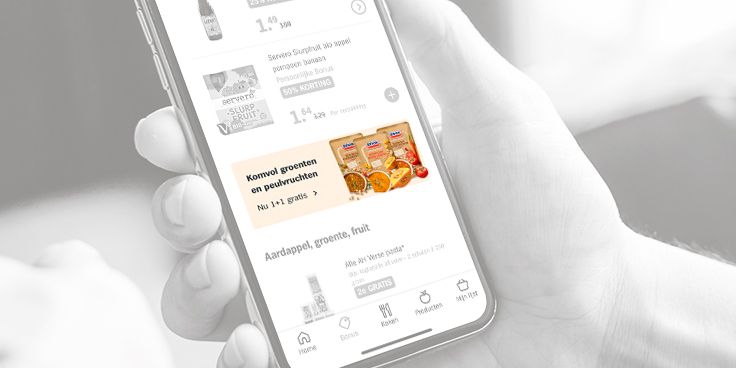 Promotie van 1+1 gratis op Komvol groenten en peulvruchten op een smartphone scherm.