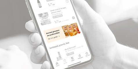 Promotie van 1+1 gratis op Komvol groenten en peulvruchten op een smartphone scherm.