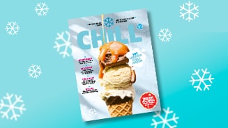 Voorpagina van Albert Heijn's "Chill" magazine met afbeelding van een ijshoorn met meerdere bollen en karamelsaus, op een blauwe achtergrond met sneeuwvlokken.