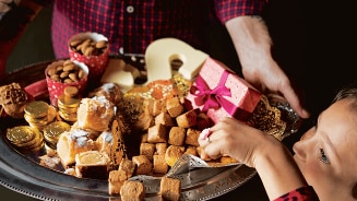 Dienblad met Sinterklaaslekkernijen zoals pepernoten, chocoladeletters, en cadeautjes