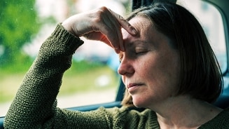 Vrouw die misselijk is in de auto.