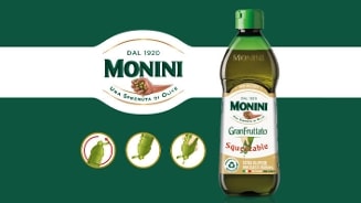 Fles Monini GranFruttato extra vergine olijfolie, squeezable verpakking, op groene achtergrond met Monini-logo en instructies voor gebruik.