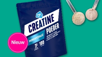 Nieuw AH Creatine Monohydraat Poeder verpakking met communicatie over verhoogde fysieke prestaties bij intensieve inspanning, inclusief twee maatlepels met poeder.