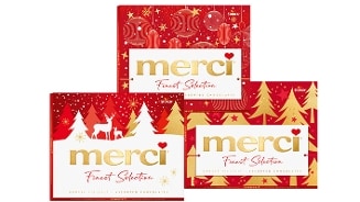 Drie feestelijke verpakkingen van Merci Finest Selection chocolade van Storck, met rode en gouden kerstdecoraties