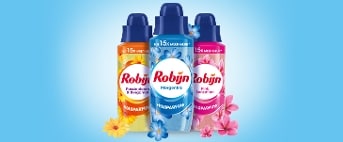 Drie flessen Robijn wasparfum in de geuren Passiebloem & Bergamot, Morgenfris en Pink Sensation op een blauwe achtergrond