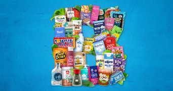 Collage van diverse producten, waaronder Bonduelle groenten, Tony's Chocolonely chocolade, Alpro plantaardige yoghurt en HAK linzen, op een blauwe achtergrond.