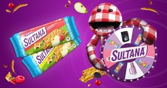 Afbeelding van Sultana fruitkoekjes in verschillende smaken, met een kleurrijke paarse achtergrond, omringd door fruit en granen, en een opvallend rad van fortuin met het Sultana-logo dat wordt vastgehouden door een rood-wit geruite pop.