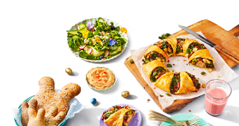 Vegetarische Paasbrunch van Albert Heijn met een salade, hartige taart, brood in handvorm en een groentekrans.