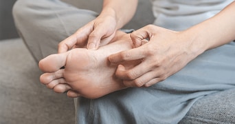 Persoon die voet onderzoekt