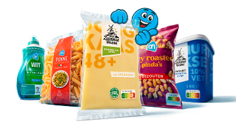 Verschillende Albert Heijn huismerkproducten, waaronder wasmiddel, penne pasta, jonge kaasplakken De Zaanse Hoeve, gezouten pinda's en Griekse yoghurt, met een blauwe mascotte op de achtergrond.