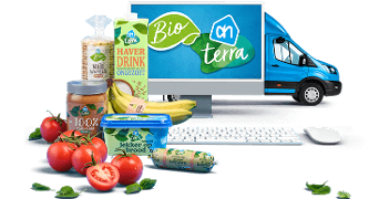 Albert Heijn Bio-producten met computer en bestelbus, inclusief tomaten, bananen, en diverse biologische voedingswaren