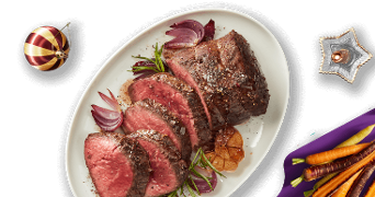 Gesneden ossenhaas op ivoorwit bord met daarbij regenboog wortelmix