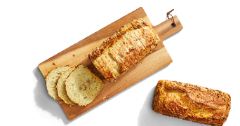 Oerdesem maisbrood in heel en gesneden op een broodplank