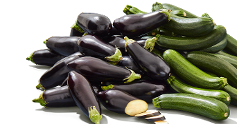 Aubergines en courgettes opgestapeld, met een paar plakjes gesneden aubergine op de voorgrond.