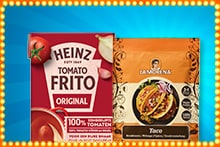 Twee verpakkingen naast elkaar: Heinz Tomato Frito Original en La Morena Taco kruidenmix, tegen een blauwe achtergrond met verlichte rand.