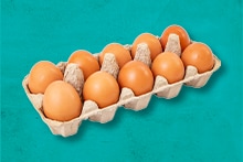 Tien bruine eieren in een kartonnen eierdoos.