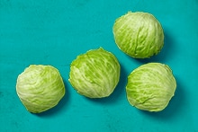 Vier kroppen ijsbergsla op een blauwe achtergrond