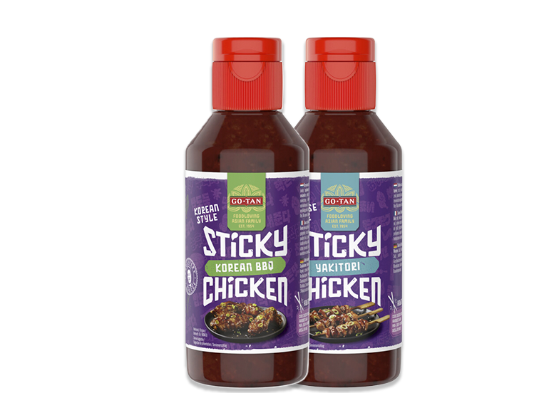 Twee flessen Go-Tan sticky chicken saus in de smaken Korean BBQ en Yakitori, met paarse etiketten en rode doppen.