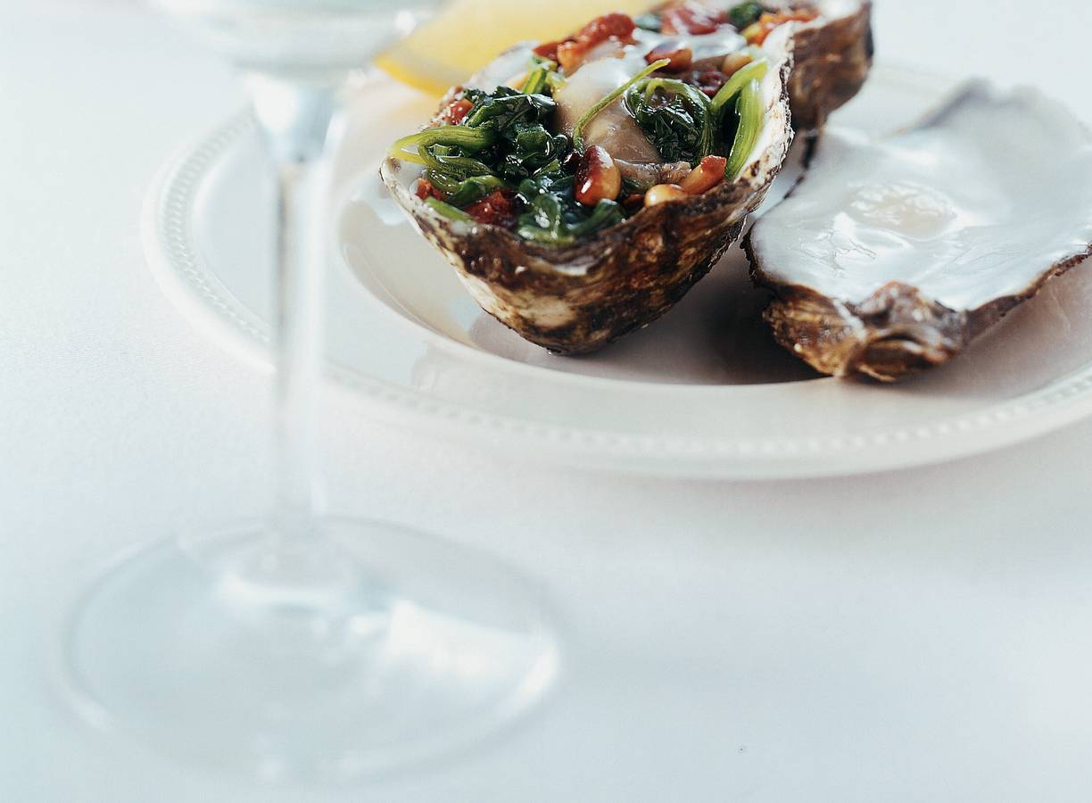 Oesters op een bedje van spinazie met zongedroogde tomaat