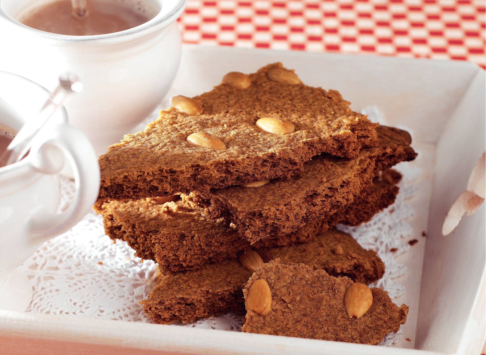 Fresh ginger and cardamom pods on a kitchen counter