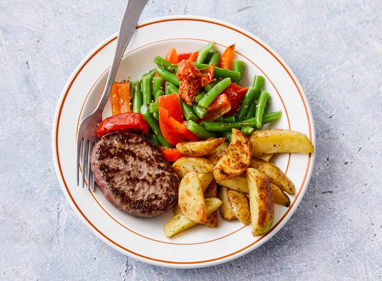 Steak de boeuf met gebakken aardappel en sperziebonen