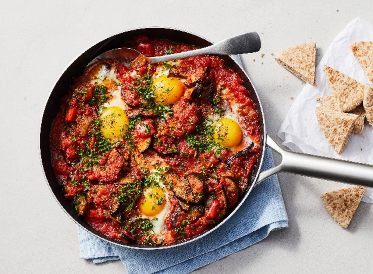 Gezonde shakshuka met aubergine, paprika, tomaat en volkoren pita